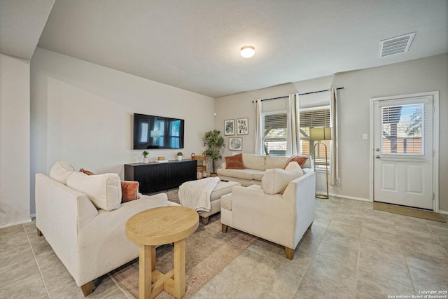 tiled living room featuring a wealth of natural light