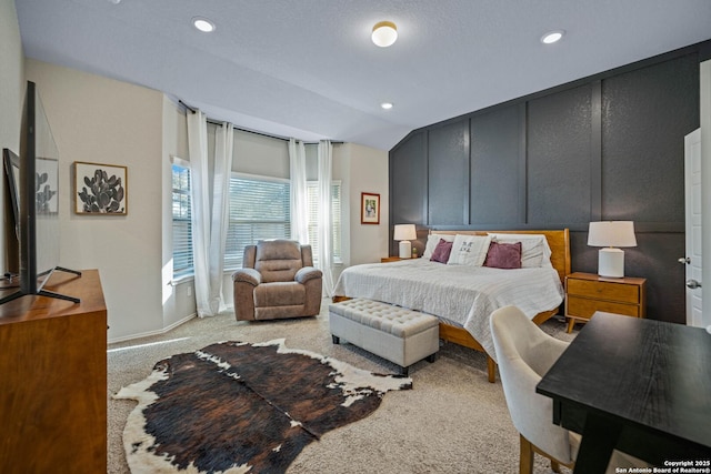 bedroom featuring lofted ceiling and light carpet