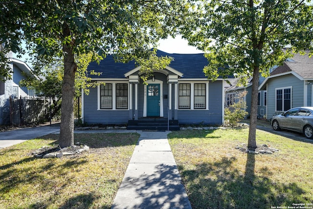 bungalow-style house with a front lawn