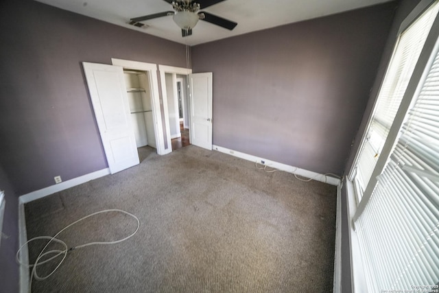 unfurnished bedroom featuring ceiling fan, carpet floors, and multiple windows