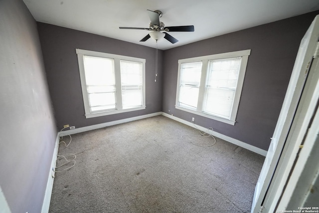 carpeted empty room with plenty of natural light and ceiling fan