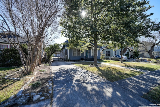 view of property hidden behind natural elements featuring a front yard