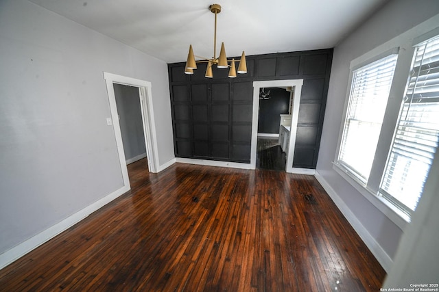 unfurnished dining area with dark hardwood / wood-style flooring