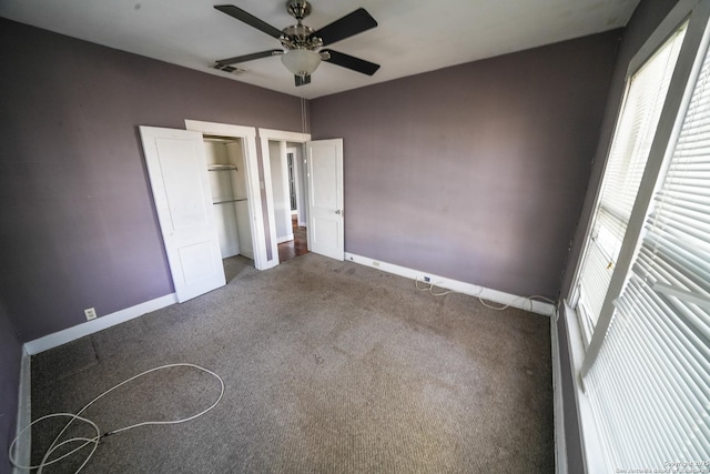 unfurnished bedroom with ceiling fan, carpet flooring, and multiple windows