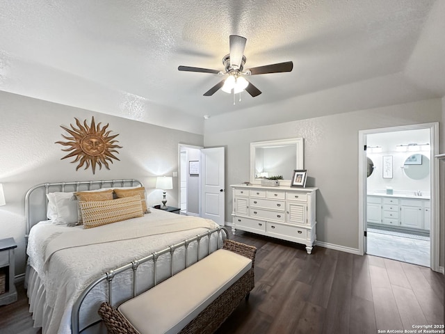 bedroom featuring ensuite bathroom, dark wood-type flooring, ceiling fan, a textured ceiling, and baseboards