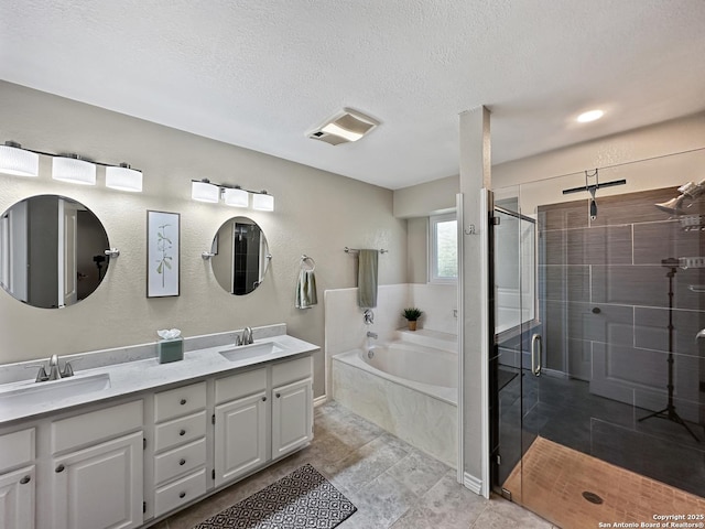 full bath with double vanity, a sink, and visible vents