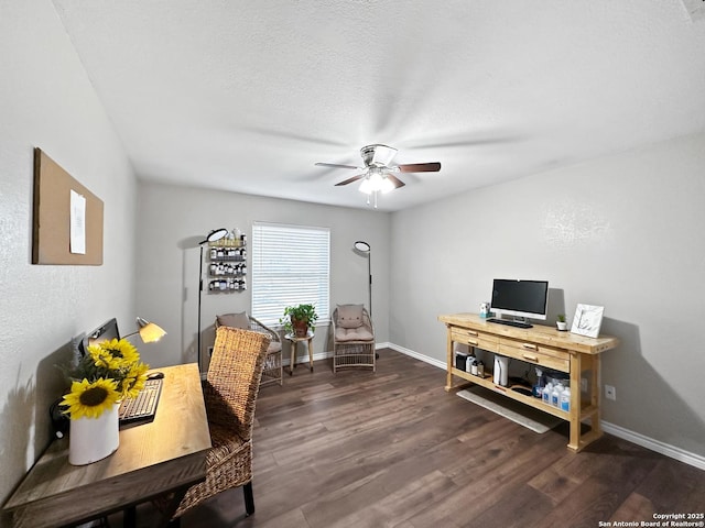 office space with ceiling fan, a textured ceiling, baseboards, and dark wood-type flooring