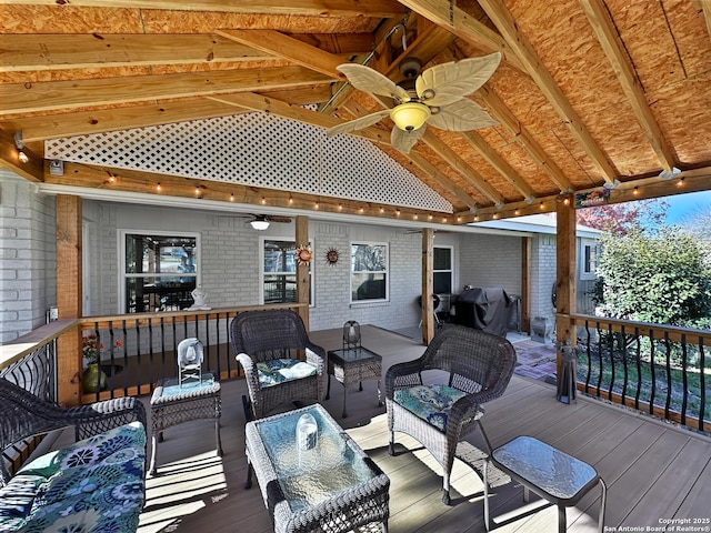 wooden terrace with ceiling fan and an outdoor living space