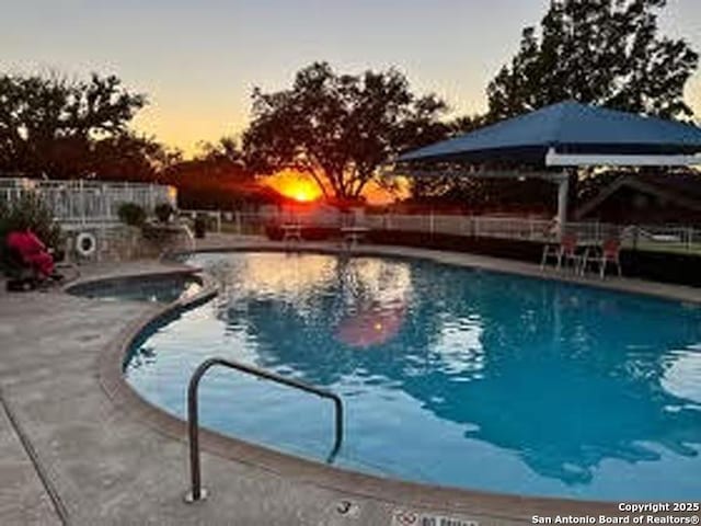 community pool featuring a patio and fence