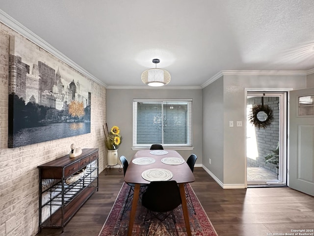 dining room with baseboards, wood finished floors, and crown molding