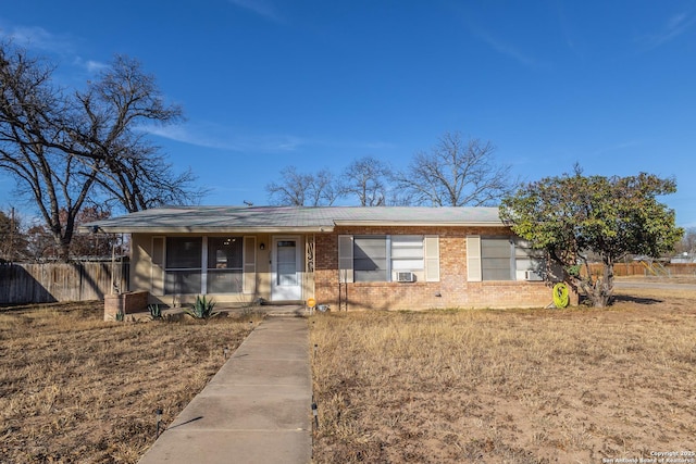 ranch-style home featuring cooling unit and a front yard