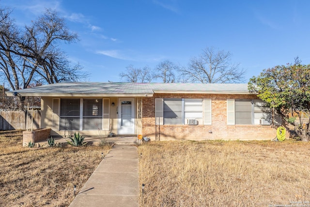 single story home featuring cooling unit and a front yard