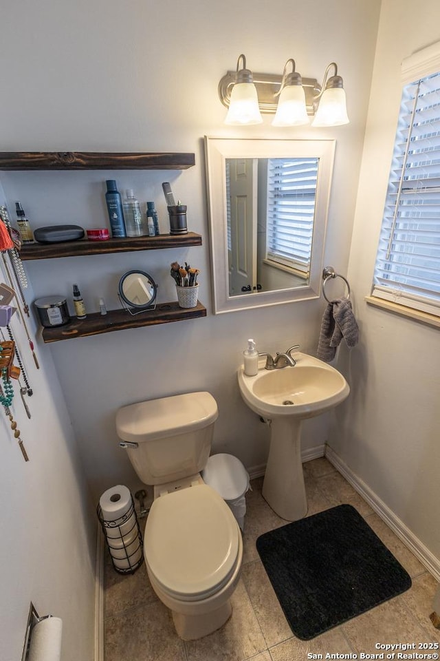 bathroom with toilet and tile patterned flooring