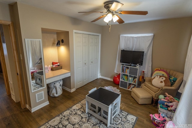 living room featuring dark hardwood / wood-style flooring and ceiling fan