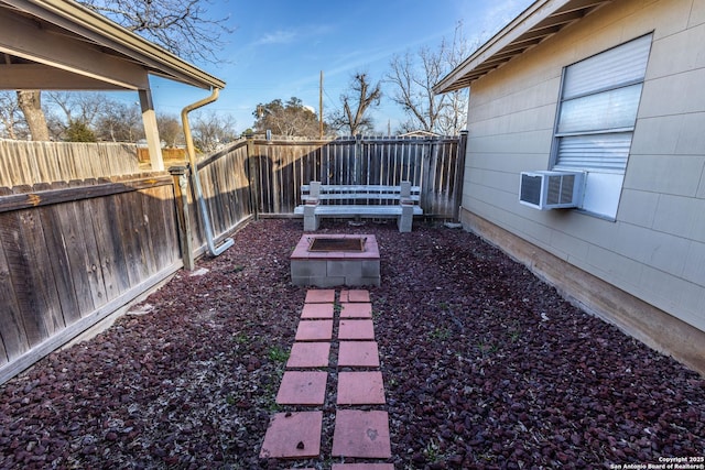 view of yard with cooling unit and a fire pit