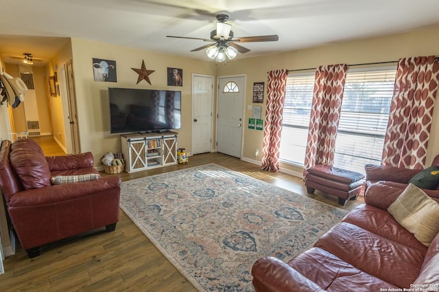 living room with hardwood / wood-style flooring and ceiling fan