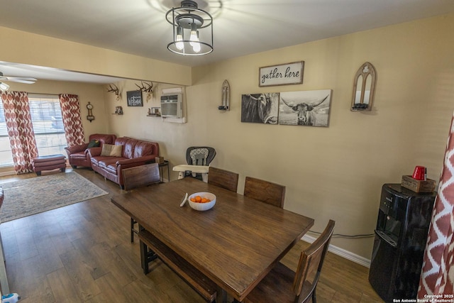 dining space featuring ceiling fan, dark hardwood / wood-style floors, and a wall unit AC