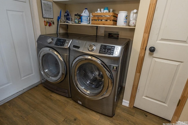 laundry area featuring dark hardwood / wood-style floors and washer and clothes dryer