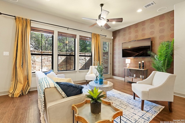 living room with ceiling fan and wood-type flooring