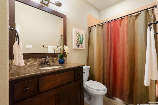 bathroom featuring vanity, decorative backsplash, tile patterned floors, and toilet