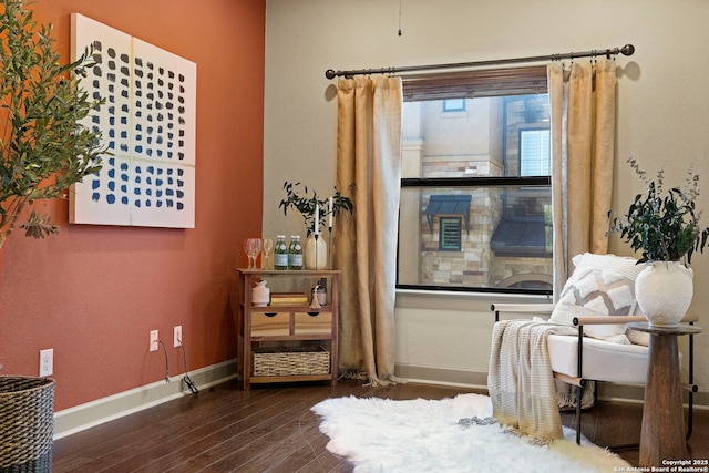 sitting room with dark wood-type flooring