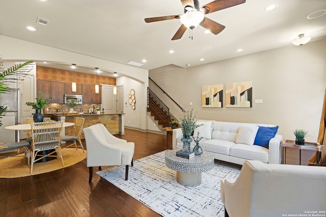 living room with dark hardwood / wood-style floors and ceiling fan