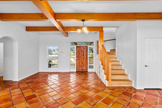 tiled foyer entrance with beam ceiling