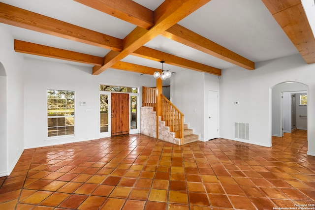 unfurnished room with beam ceiling and a chandelier