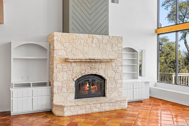 room details featuring built in shelves and a stone fireplace