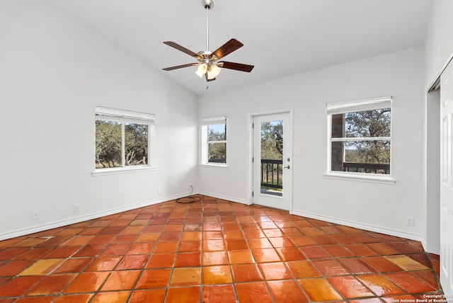 tiled spare room featuring high vaulted ceiling and ceiling fan