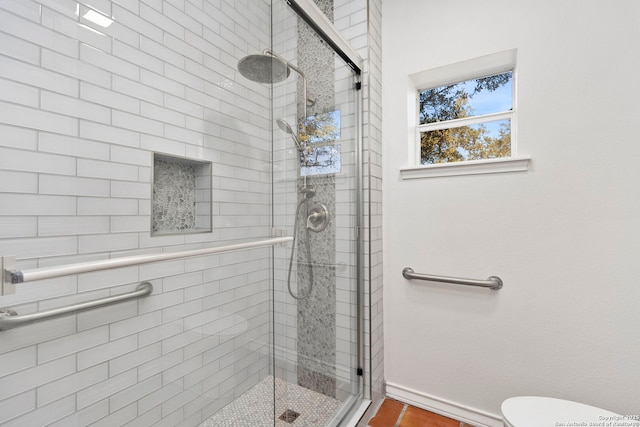 bathroom featuring an enclosed shower, tile patterned flooring, and toilet