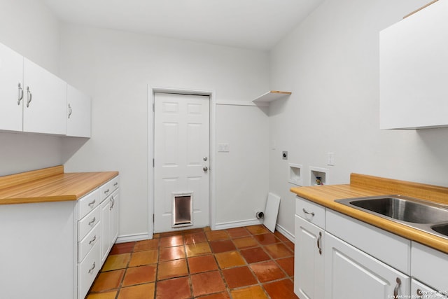 kitchen featuring sink and white cabinets