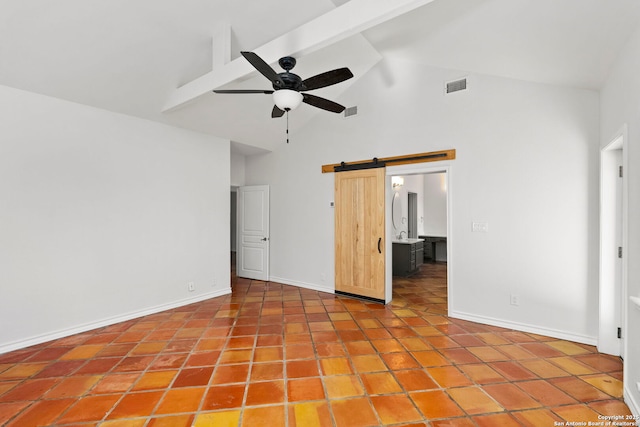 unfurnished bedroom with beamed ceiling, ceiling fan, a barn door, and high vaulted ceiling