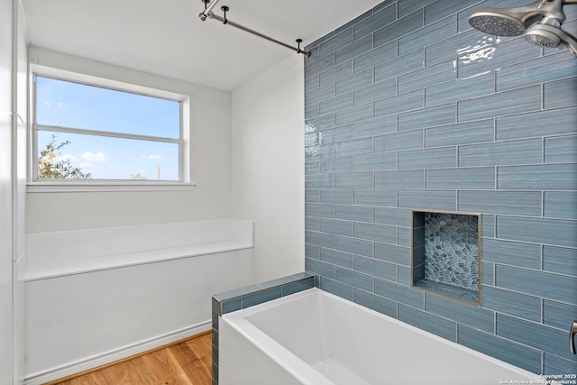 bathroom with ceiling fan, shower / tub combination, and hardwood / wood-style floors