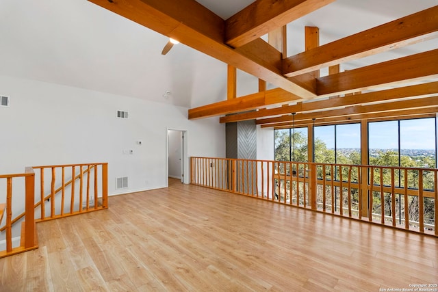 living room with beamed ceiling, ceiling fan, high vaulted ceiling, and light wood-type flooring