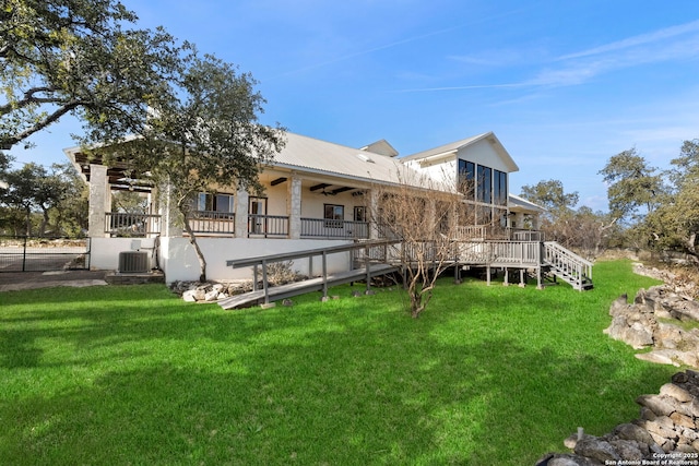 back of property featuring central AC unit, a lawn, ceiling fan, and a deck