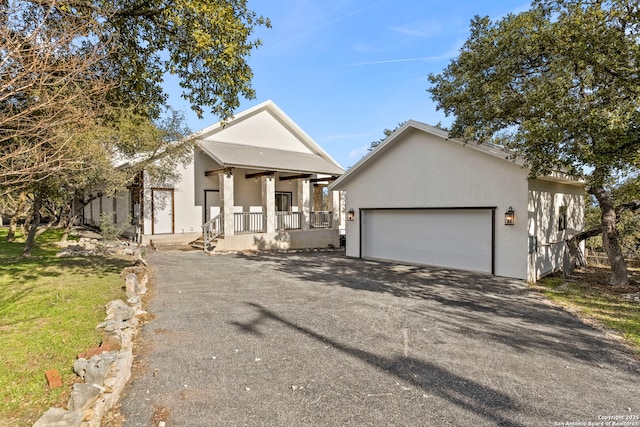 view of front facade with a porch and a garage