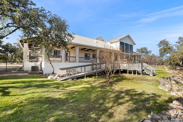 rear view of property featuring a wooden deck, a yard, ceiling fan, and central air condition unit