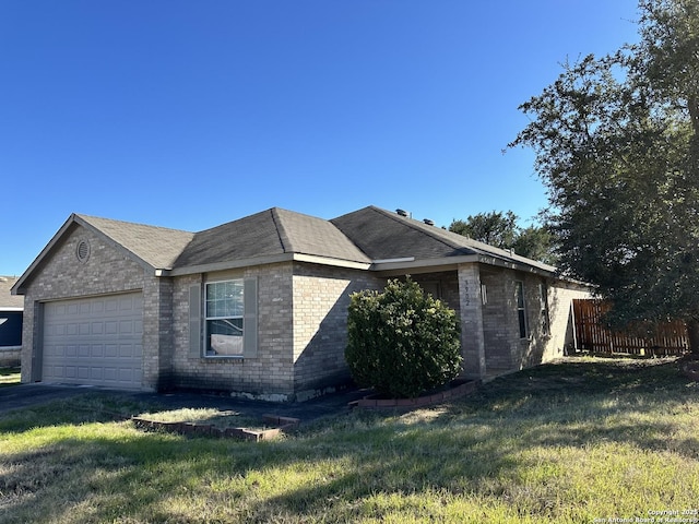 view of side of property with a garage and a lawn