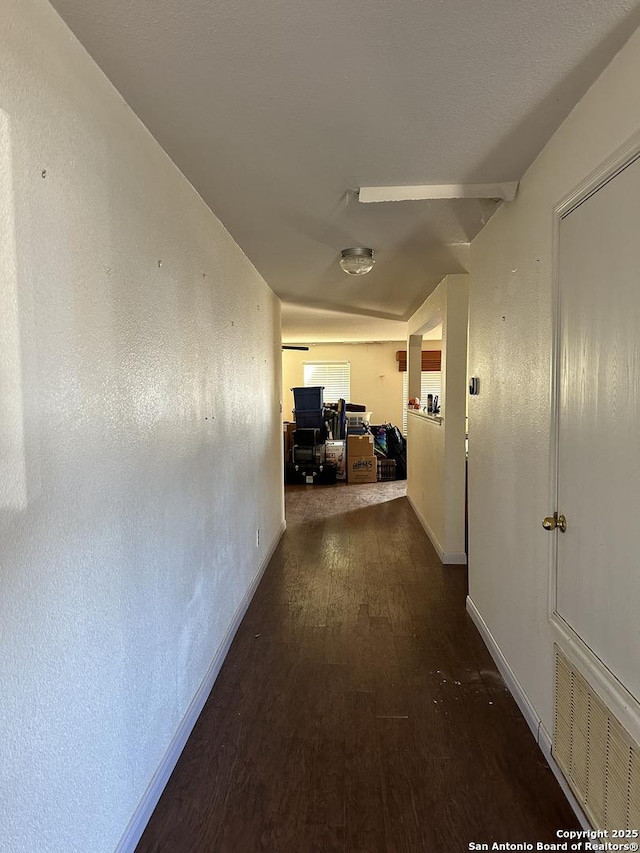 hallway with dark wood-type flooring