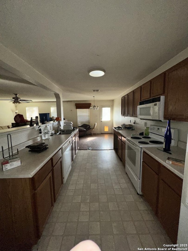 kitchen with ceiling fan, white appliances, and sink