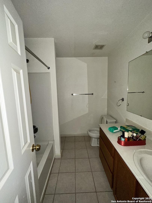 full bathroom featuring shower / washtub combination, vanity, a textured ceiling, tile patterned floors, and toilet