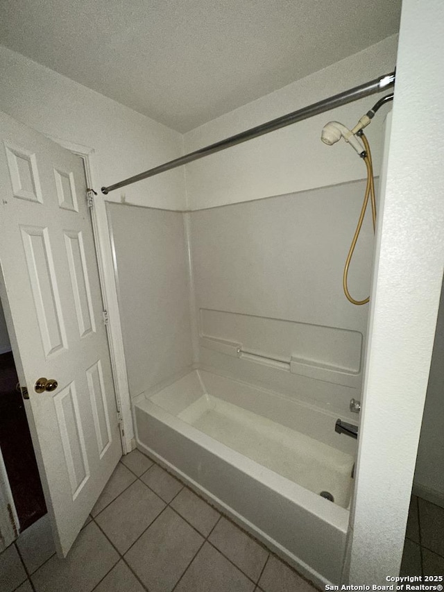 bathroom with tile patterned flooring and shower / bathtub combination