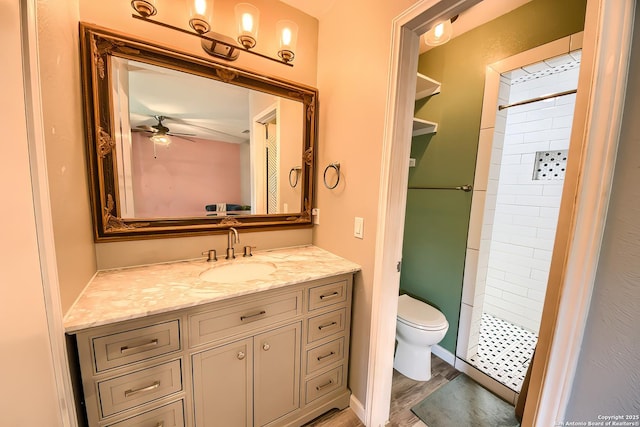 bathroom with walk in shower, toilet, wood-type flooring, vanity, and ceiling fan