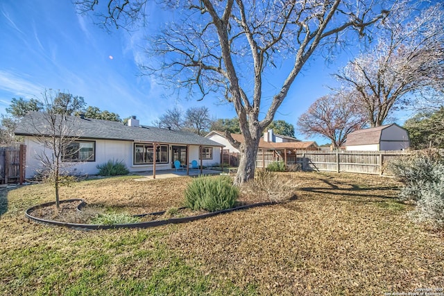 rear view of house featuring a yard and a patio area