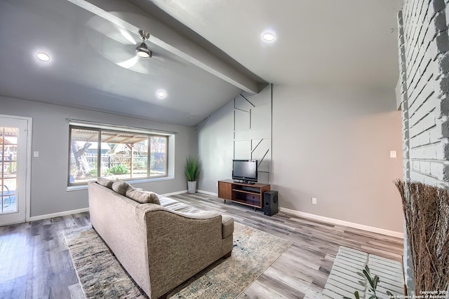 living room featuring vaulted ceiling with beams, hardwood / wood-style floors, and ceiling fan