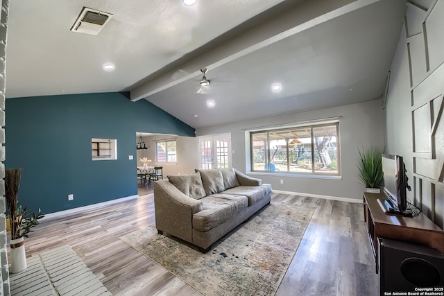 living room with vaulted ceiling with beams, plenty of natural light, light hardwood / wood-style floors, and ceiling fan