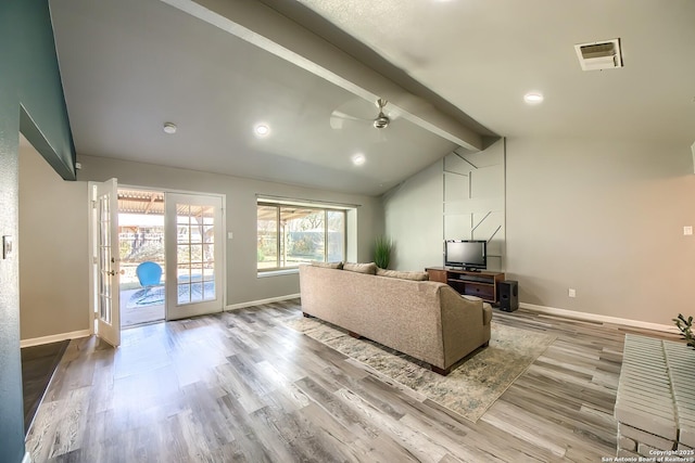 living room with ceiling fan, vaulted ceiling with beams, light hardwood / wood-style floors, and french doors