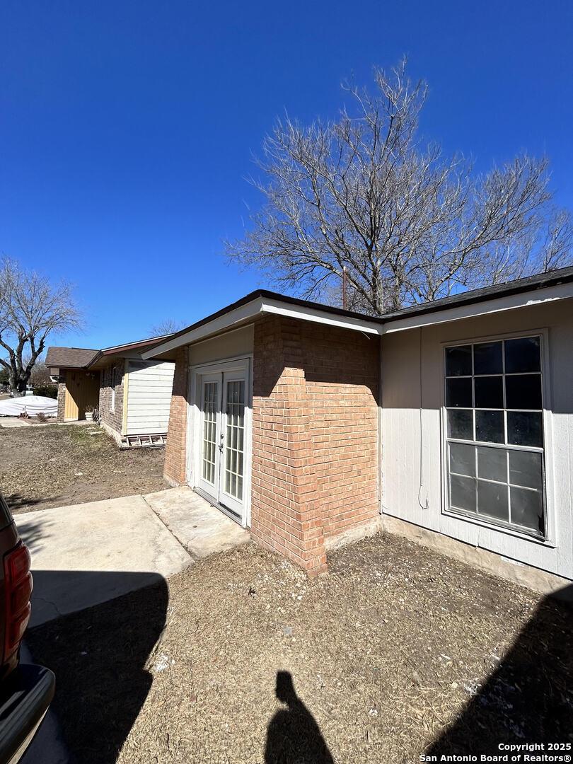 view of property exterior featuring french doors and a patio