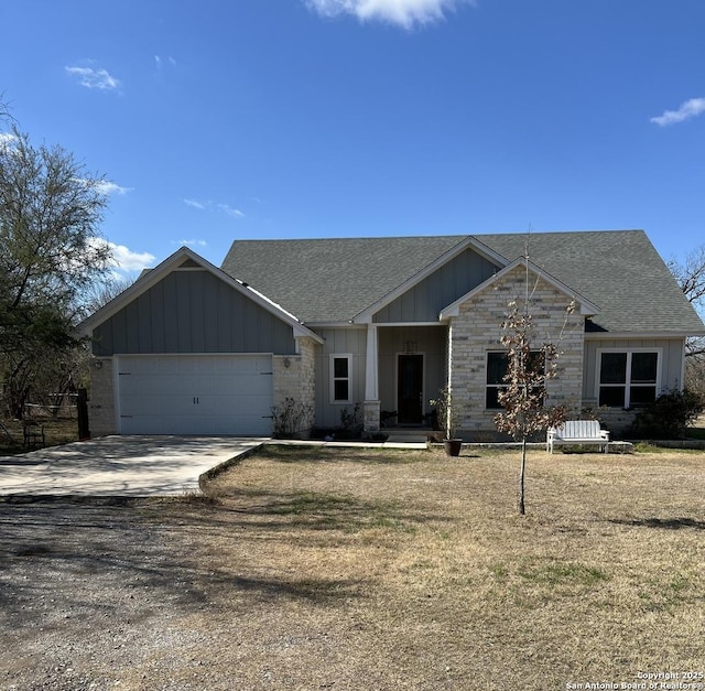 view of front of home with a garage and a front lawn